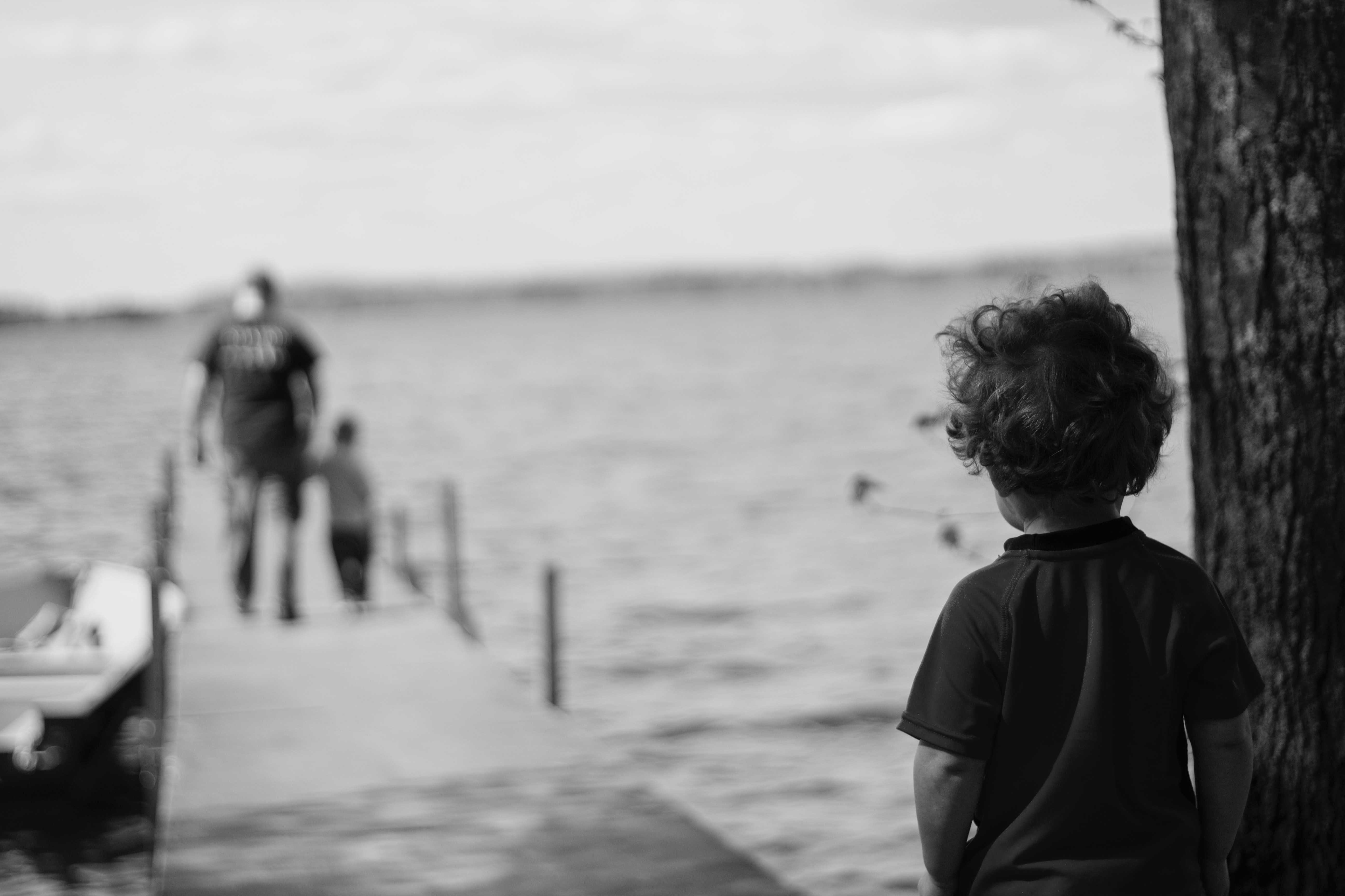 Photo of a child victim of sexual abuse near a dock