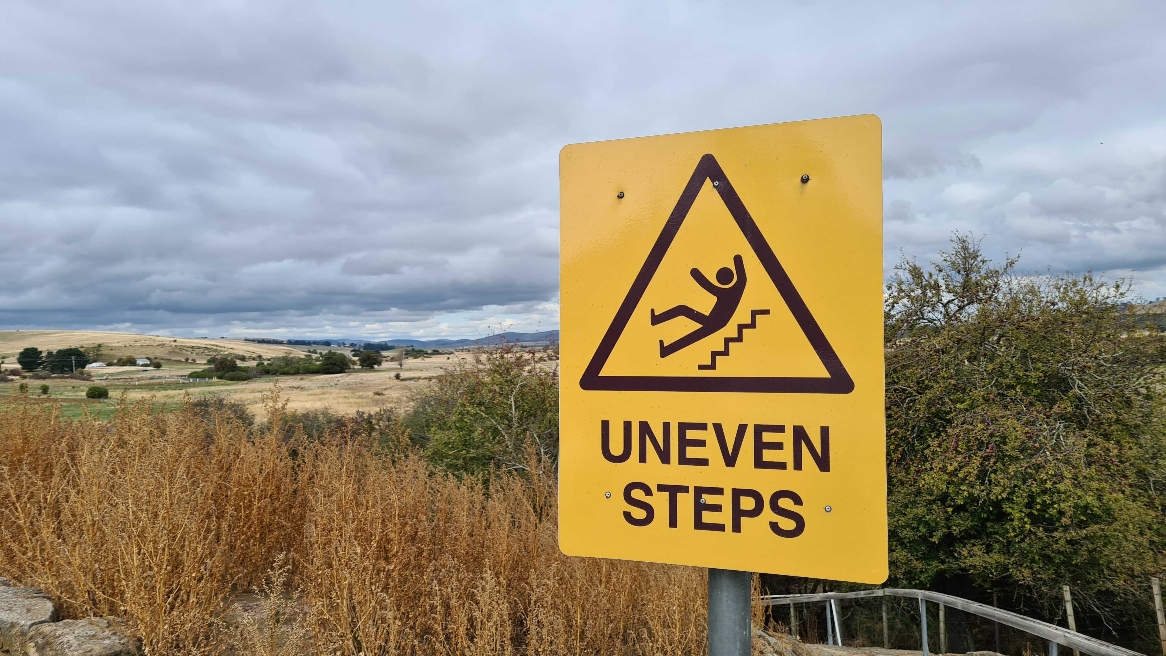 A sign outside which reads 'uneven steps'